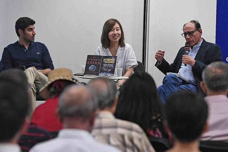 Indian-American global strategy adviser Parag Khanna (far left) and ST associate editor Vikram Khanna (left) discussing their books at Wednesday's Straits Times Book Club, moderated by ST opinion editor Audrey Quek.