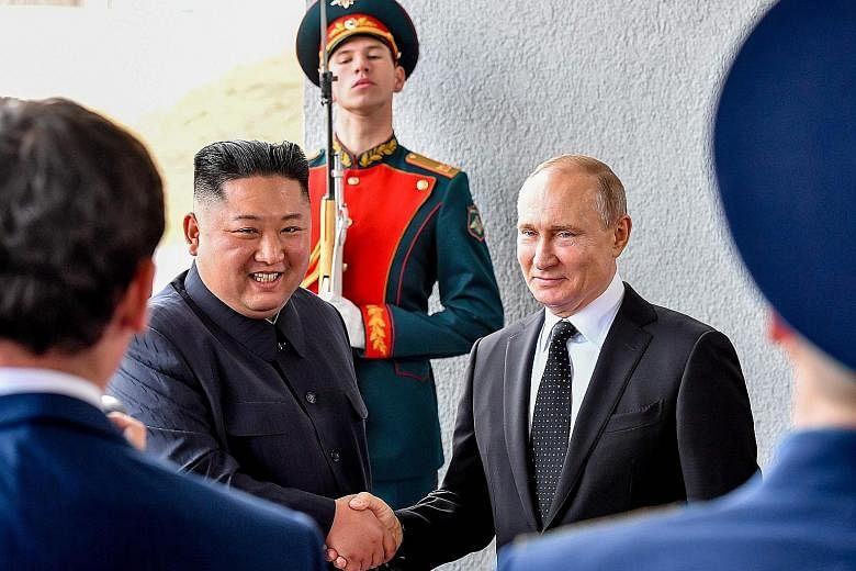 Russian President Vladimir Putin welcoming North Korean leader Kim Jong Un before their talks at the Far Eastern Federal University campus on Russky Island in the far-eastern Russian port of Vladivostok yesterday. The summit was the first between lea