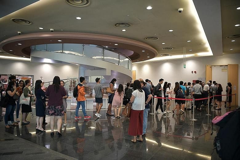 Students queueing to get into the town hall meeting at NUS University Town yesterday. Several times during the session, the university's representatives deferred issues raised to the committee to review NUS' disciplinary and support frameworks, which
