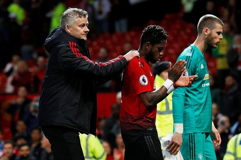 Manchester United manager Ole Gunnar Solskjaer consoling midfielder Fred following the 2-0 Premier League loss to Manchester City on Wednesday, as goalkeeper David de Gea also looks dejected in the background. It was United's seventh defeat in nine m