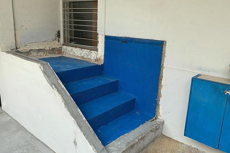 The now bare staircase landing (above) outside a Tampines flat, after a fish tank (left) built on it three to four years ago was removed this week. Citing safety reasons, the HDB said the owner could not keep it.