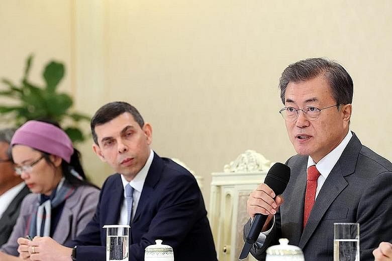 South Korean President Moon Jae-in speaking to visiting editors from Asia News Network, including Straits Times editor Warren Fernandez (centre), at the presidential Blue House in Seoul yesterday. Noting that United States President Donald Trump and 