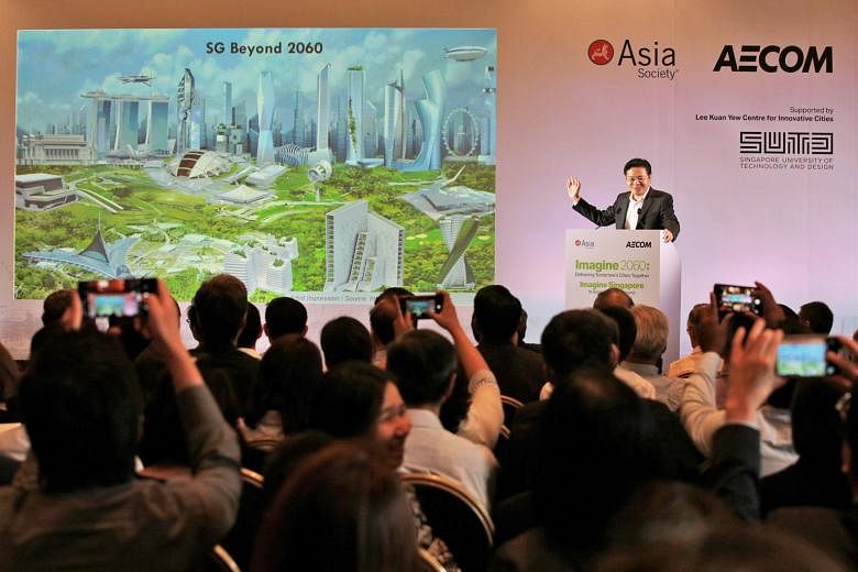 National Development Minister Lawrence Wong showing an artist's impression of Singapore beyond 2060 at the Imagine 2060 forum at the Asian Civilisations Museum yesterday.