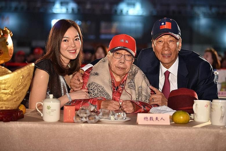 Mr Terry Gou with his wife and his mother. When asked by reporters for his reaction to his wife's departure, Mr Gou said "the harem should not meddle in politics", sparking backlashfrom the public.