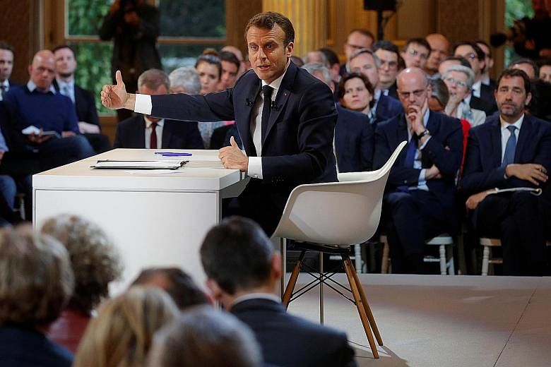 French President Emmanuel Macron at a news conference to unveil his policy response to the "yellow vest" protests. He has offered €5 billion (S$7.6 billion) of cuts to income tax and has promised education reforms.