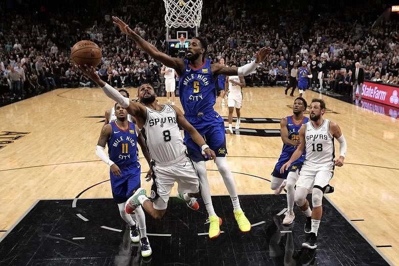 San Antonio's Patty Mills going for the basket while under pressure from Denver Nuggets' Will Barton during Game 6 of their NBA play-off first-round series. Spurs won 120-103.