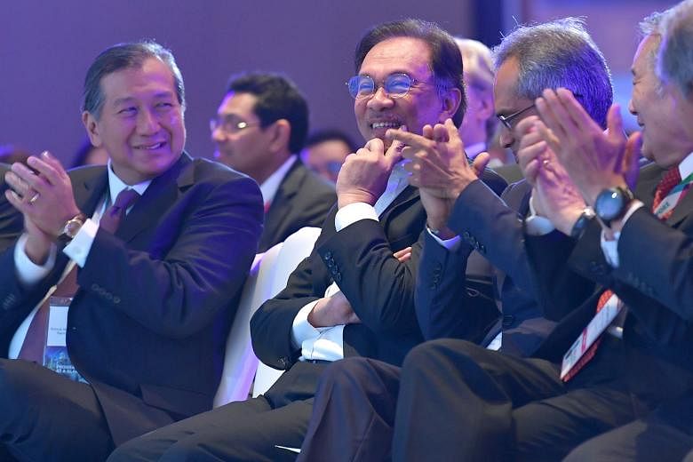 Datuk Seri Anwar Ibrahim (second from left) discussing the present and future challenges facing Malaysia and the region at the IPBA event yesterday. With him are (from left) IPBA president Perry Pe, moderator Francis Xavier, and Justice Quentin Loh.