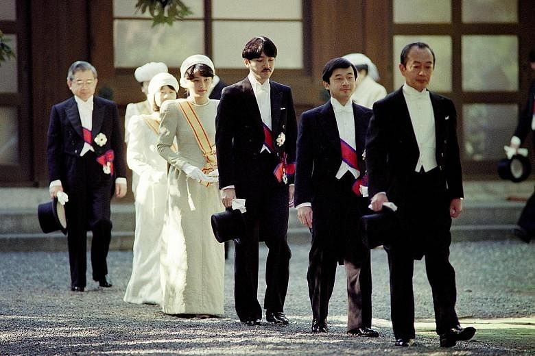 Crown Prince Naruhito (second from right) before the enthronement ceremony of his father, Emperor Akihito, on Nov 12, 1990. Walking behind him are his brother, Prince Akishino; Crown Princess Masako; and Princess Nori.
