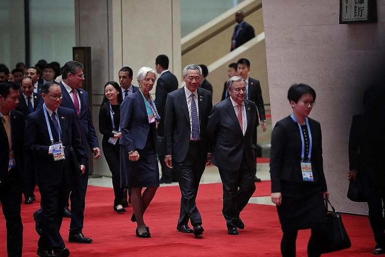 Singapore Prime Minister Lee Hsien Loong, flanked by International Monetary Fund chief Christine Lagarde and United Nations Secretary-General Antonio Guterres, on the way to a group photo session during the welcoming ceremony for China's second Belt 