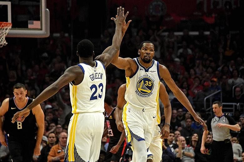 Golden State Warriors forwards Kevin Durant (right) and Draymond Green celebrating during their 129-110 win over the LA Clippers on Friday. Durant's 38 points equalled the most points scored in the first half of a play-off game.