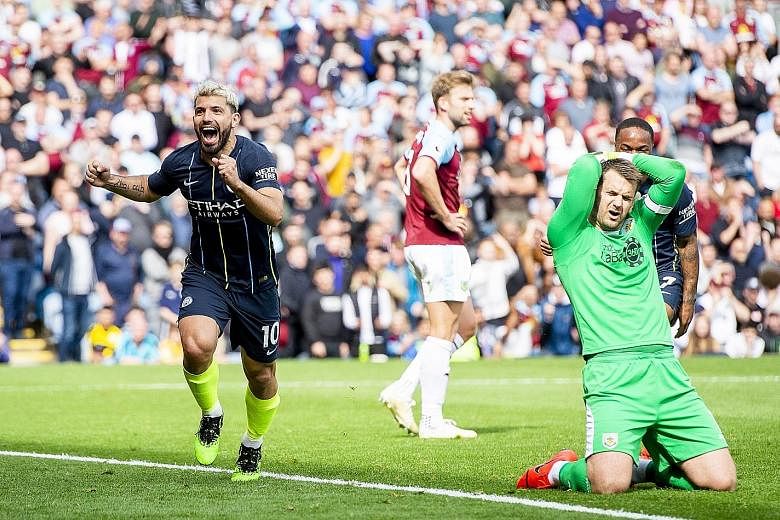 Manchester City's Sergio Aguero running to the away supporters in delight after his 63rd-minute strike gave his team a 1-0 win at Burnley yesterday. Goal-line technology was required before it was awarded and the result puts City top of the table on 