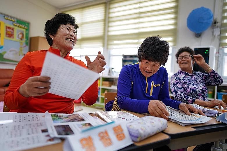 From left: Madam Hwang Wol-geum, 70, Madam Kim Mae-ye, 64, and Madam Park Jong-sim, 75, learn to read in a first-grade class at Daegu Elementary, in Gangjin county, in south-western South Korea. Daegu Elementary has only 22 pupils in total, including
