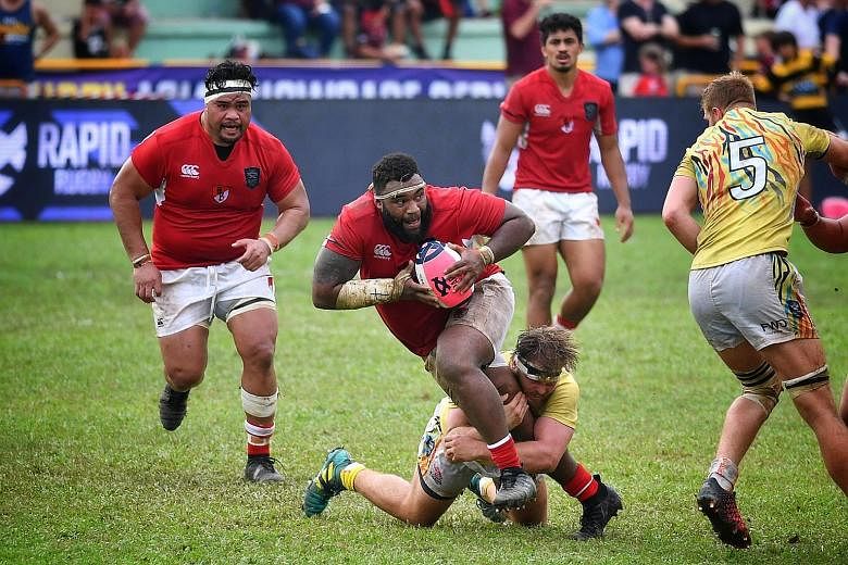 Asia Pacific Dragons' prop Ropate Rinakama getting tackled in yesterday's Global Rapid Rugby match against the South China Tigers at the Queenstown Stadium. The Dragons won 41-26.