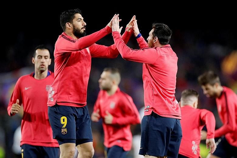 Barcelona's Luis Suarez (No. 9) and Lionel Messi will lead the Spanish champions' attack when they host Liverpool at the Nou Camp today.