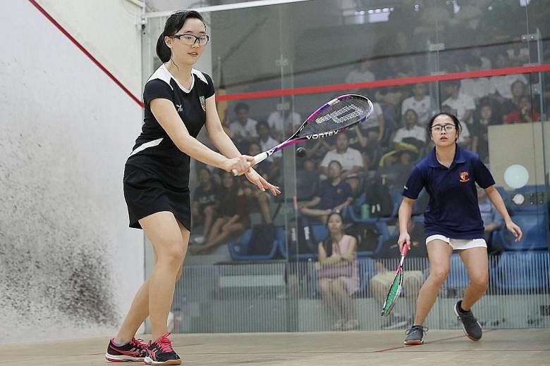 Captain Nicole Tong (far left) beating ACJC's Jewel Tan 11-0, 11-0, 11-3 to give RI a 2-0 lead in the Schools National A Division girls' squash final at Kallang Squash Centre yesterday. RI won 5-0.