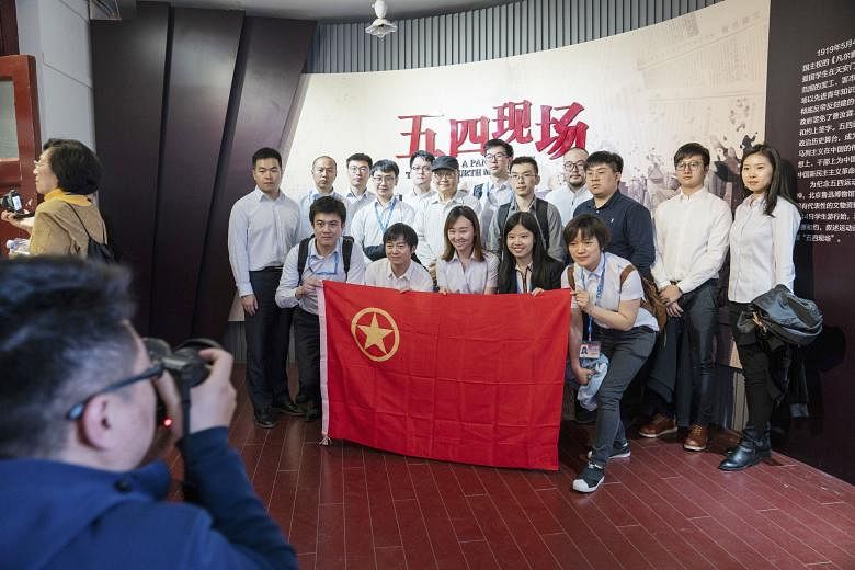 Visitors taking a photo with a Chinese Communist Youth League flag at an exhibition in the New Culture Movement Memorial Museum in Beijing late last month. On May 4, 1919, students led a protest against Western colonialism that inflamed Chinese natio