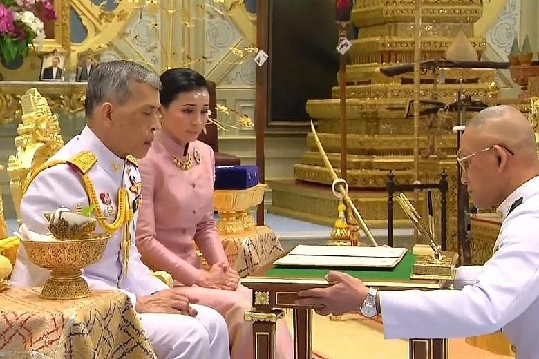 A screengrab from Thai TV Pool video showing King Maha Vajiralongkorn and Ms Suthida Vajiralongkorn Na Ayudhya in their marriage ceremony in Bangkok. Queen Suthida is the King's fourth wife. He has five sons and two daughters from his previous marria
