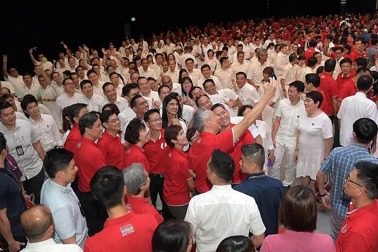 Prime Minister Lee Hsien Loong taking a wefie with Deputy Prime Minister Heng Swee Keat, other ministers and NTUC leaders, as well as the PAP contingent, at Downtown East yesterday. In his first May Day Rally speech, Mr Heng spoke of how the "close w