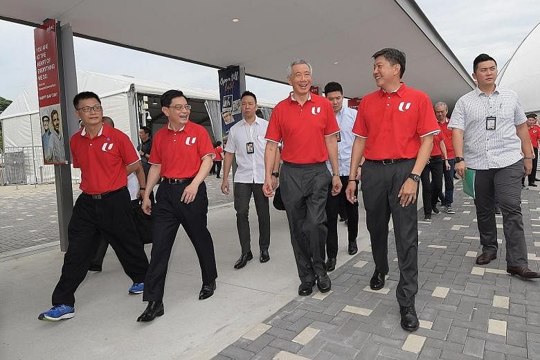 (Front, from left) NTUC vice-president Tan Hock Soon, Deputy Prime Minister Heng Swee Keat, Prime Minister Lee Hsien Loong and labour chief Ng Chee Meng at Downtown East, where Mr Heng addressed 1,600 unionists, workers, employers and Cabinet ministe