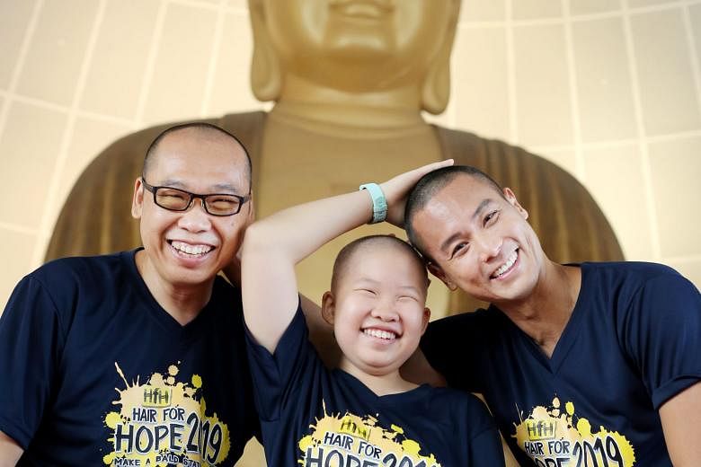 (From left) Mr Chong Hui Kwee, Joanna Chong and actor Andie Chen with freshly shaved heads in support of the Hair for Hope event, organised by the Children's Cancer Foundation (CCF). Through the event, CCF aims to raise awareness of childhood cancer.