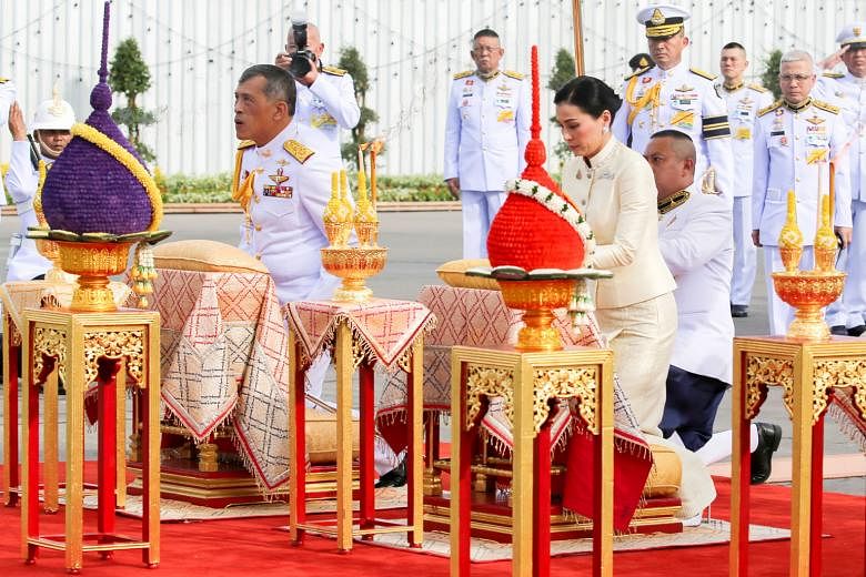 Thailand's King Maha Vajiralongkorn and Queen Suthida paying their respects before the statue of King Rama V at the Royal Plaza in Bangkok yesterday. The monarch's coronation, which takes place from tomorrow to Monday, will be the first the country h