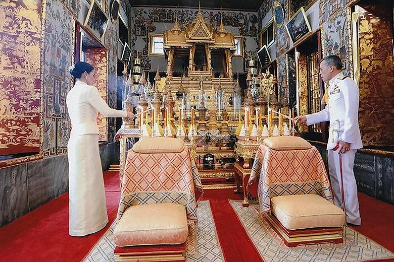A Thai Royal Household Bureau photo showing King Maha Vajiralongkorn and Queen Suthida paying their respects at the Bangkok City Pillar Shrine on Thursday. As the wife of Thailand's ruler - who is reportedly the world's richest monarch with assets of