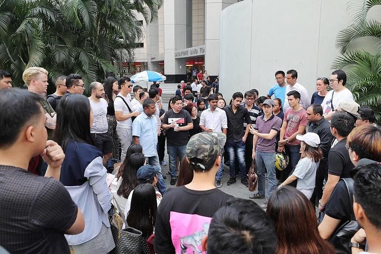 Sear Steakhouse is one of the four affected establishments. The other three are Angie's Oyster Bar, Empire Sky Lounge and Lower East Side 45. Fifty Raffles Place managing director Christopher Lim (wearing cap) speaking to his staff outside the Singap