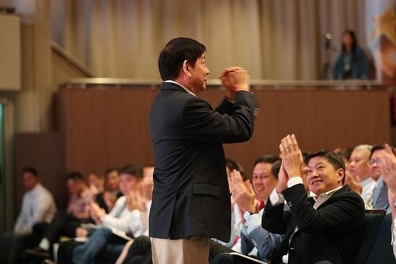Transport Minister and Coordinating Minister for Infrastructure Khaw Boon Wan acknowledging a round of applause at the award ceremony yesterday. NTUC said in its citation for the Medal of Honour that Mr Khaw's belief in prioritising workers and his e