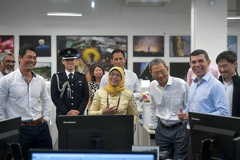 (From right) SPH deputy chief executive officer Anthony Tan, ST editor Warren Fernandez and SPH chairman Lee Boon Yang showing President Halimah Yacob the revamped ST newsroom yesterday. With them are (from left) ST associate editor Paul Jacob; Mr Eu