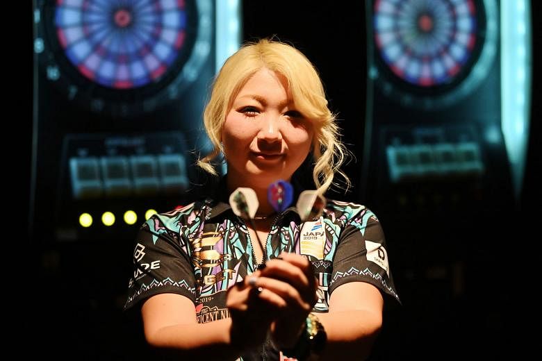 Described as the Phil Taylor of women's darts, Japan's Mikuru Suzuki has plans to dominate the sport after becoming the first Asian player to capture a world title. PHOTO: AGENCE FRANCE-PRESSE