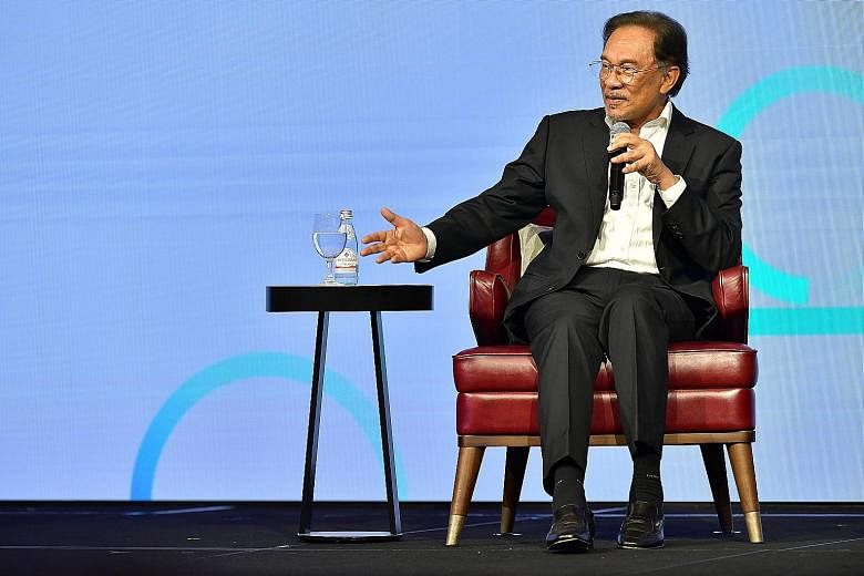 Malaysia's prime minister-in-waiting Anwar Ibrahim at an event in Singapore last month. He was quoted in a Bloomberg report as saying that he expected to take power from Dr Mahathir in less than two years, but the wait seems longer than expected, rai