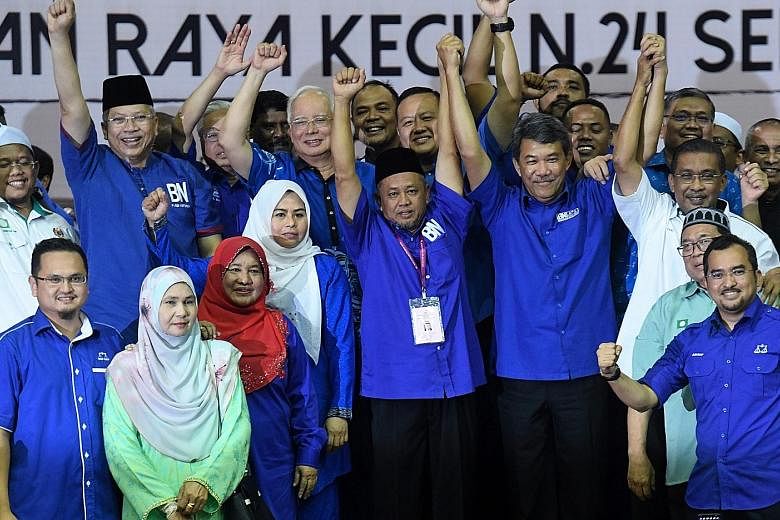 Mr Zakaria Hanafi (centre), Barisan Nasional's candidate for the Semenyih state assembly seat, celebrating his by-election victory on March 2 with fellow opposition party members, including Najib Razak (behind him). The polls result showed a big Mala