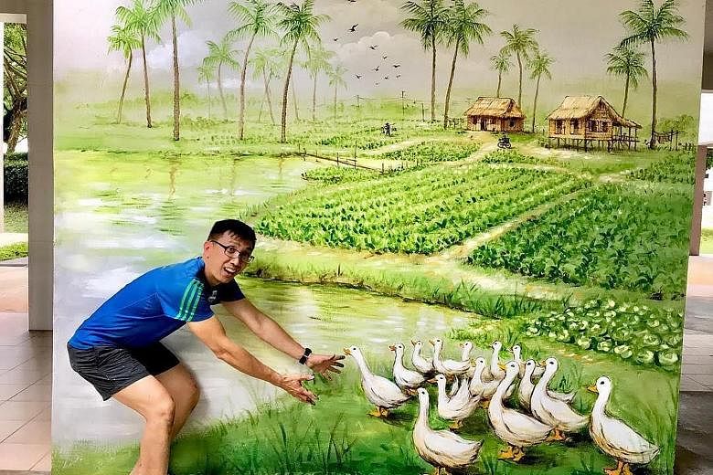 Mr Yip in Penang with a mural titled Folklore By The Sea (left), which he completed last December, and with another mural, titled From Farmland To A Modern City - in Woodlands Drive 62 - which he completed in March.