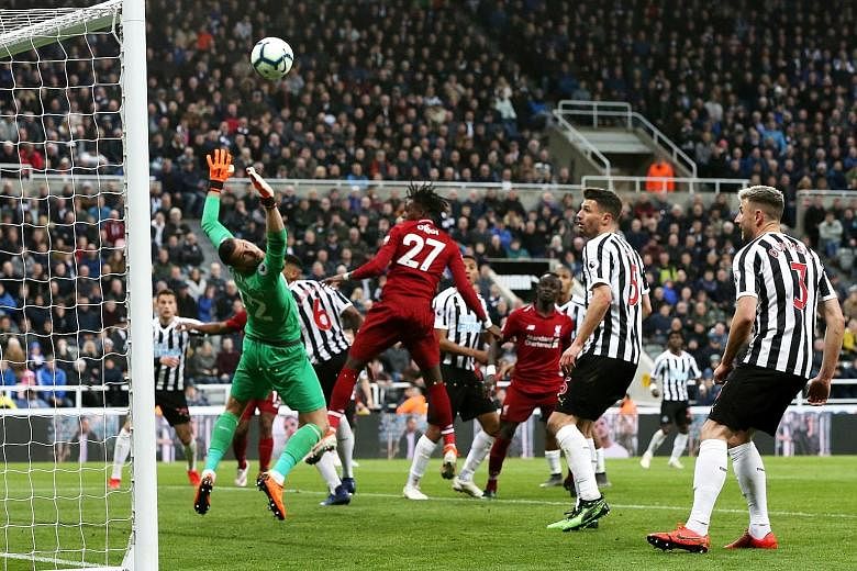 Substitute Divock Origi heading home against Newcastle to give Liverpool the lead late in the game. The Reds won 3-2 to take their race with Manchester City for the Premier League title to the season's final weekend. PHOTO: EPA-EFE