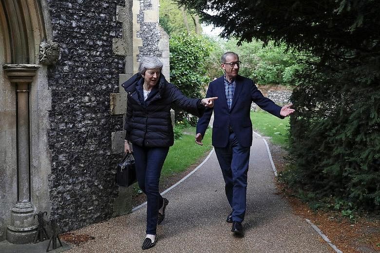 British Prime Minister Theresa May and her husband Philip arriving for a church service yesterday in Sonning, Berkshire. Her Conservative Party and the main opposition Labour took a clobbering in last Thursday's local elections.