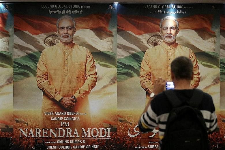 Posters of the film, PM Narendra Modi, in Mumbai. Over 300 million Indians are on WhatsApp and the ruling Bharatiya Janata Party is using it to wage one of the world's most sophisticated digital political campaigns, carried out by a vast army of volu