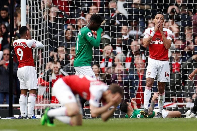 Arsenal's Pierre-Emerick Aubameyang (right) and teammates in disbelief after his miss during the Premier League game against Brighton at the Emirates on Sunday. The teams drew 1-1. PHOTO: REUTERS