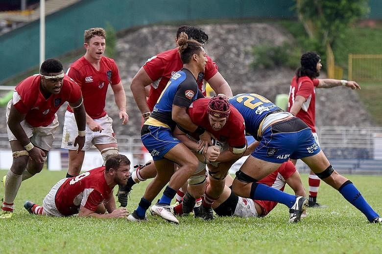 Above: Global Rapid Rugby founder Andrew Forrest's vision is to spread the love of rugby across Asia. Left: The Singapore-based Asia Pacific Dragons (in red) battling Australia's Western Force in their Global Rapid Rugby match last Sunday at Queensto