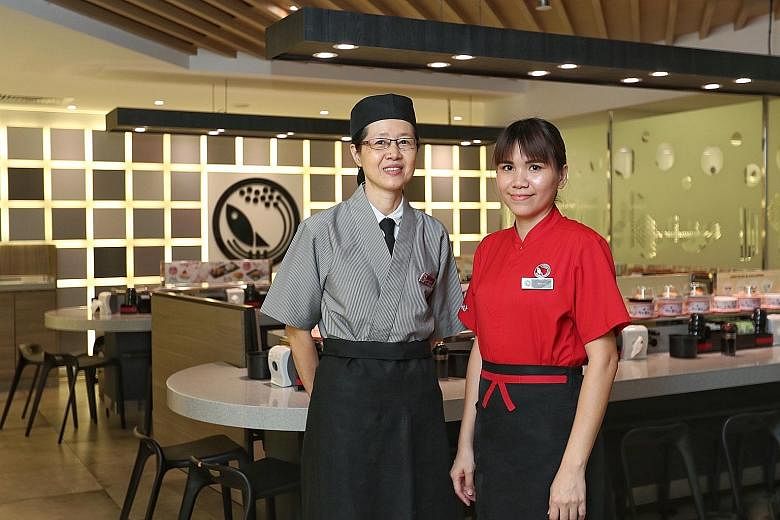 Kitchen worker Yeo Seck Eng (left), 56, and service worker Jessie Leu, 33, work at the Sushi Express outlet at Sun Plaza. Both said it takes understanding and respect for younger and older employees to get along with each another, and the simple act 