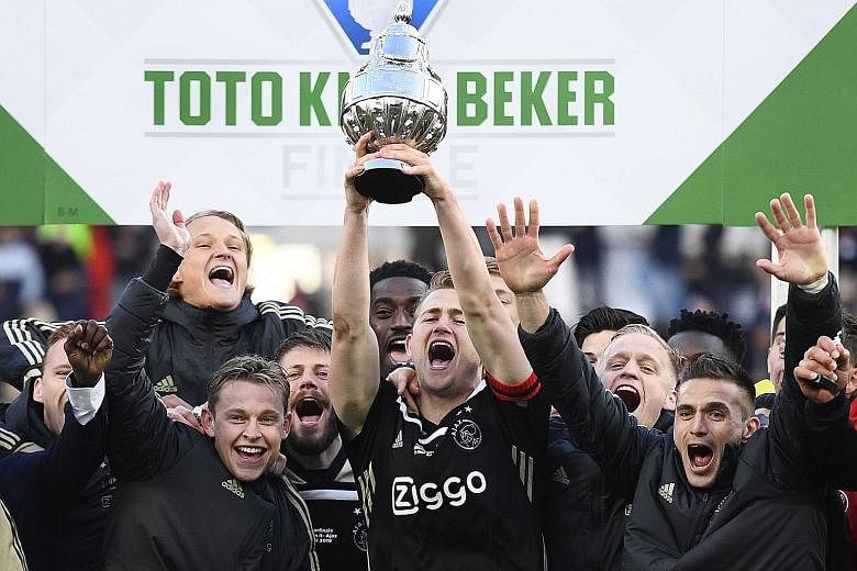 The emergence of promising young players like Frenkie de Jong, Donny van de Beek and Matthijs de Ligt (centre, celebrating Ajax's Dutch Cup victory last Sunday), has been largely down to the work of their coach Erik ten Hag. PHOTO: EPA-EFE
