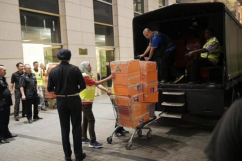 A police truck being loaded with items seized from a luxury condominium linked to former Malaysian PM Najib Razak last year. Najib will challenge the two suits that were filed on Tuesday, his lawyer Muhammad Shafee Abdullah said.