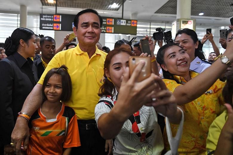 Mr Prayut Chan-o-cha, taking photos with supporters last month, has been nominated as prime minister by Palang Pracharath Party.