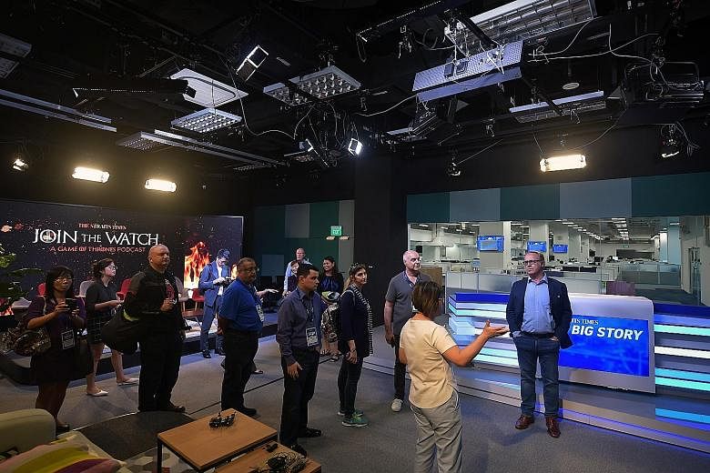 Delegates of Publish Asia 2019 getting a look at what goes on behind the scenes of The Straits Times' new daily talk show, The Big Story, in its broadcast studio.