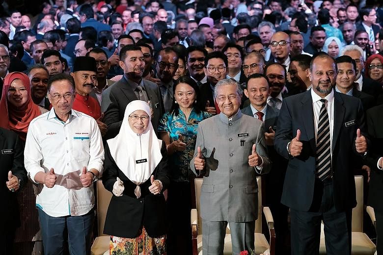 From far left: Datuk Seri Anwar Ibrahim, Malaysia's premier-in-waiting, Deputy Prime Minister Wan Azizah Wan Ismail, Prime Minister Mahathir Mohamad, and Communications and Multimedia Minister Gobind Singh Deo making the thumbs-up gesture at yesterda