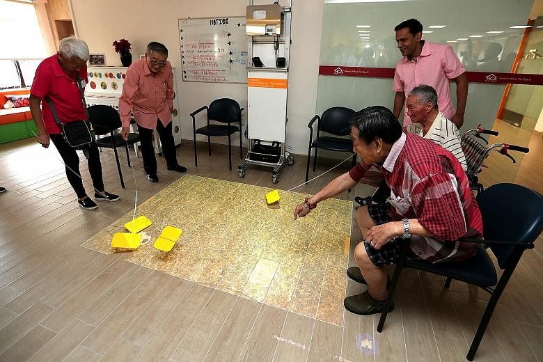 Patients playing games at HCA Hospice Care's new premises at Kwong Wai Shiu Hospital, which officially opened yesterday. The hospice, which moved from its previous location in Jalan Tan Tock Seng in November last year, has waived charges for all its 