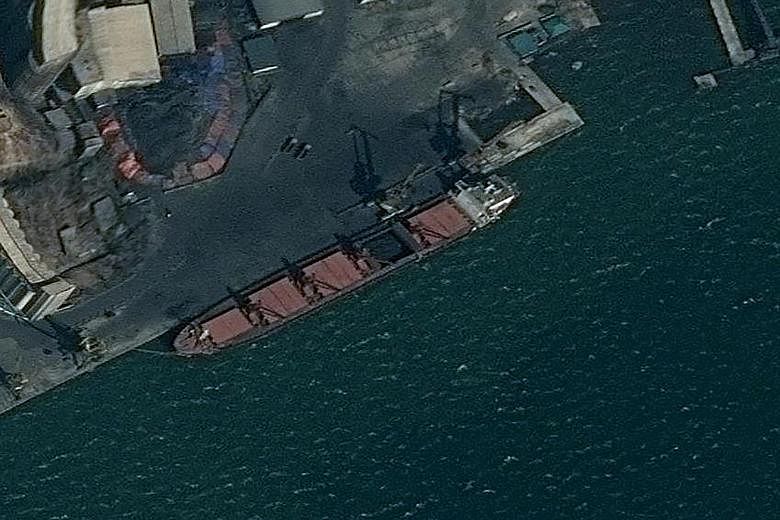 A surveillance image provided by the US Department of Justice showing the North Korean vessel Wise Honest being loaded with coal in Nampo. The US says the ship was being used to export North Korean coal.