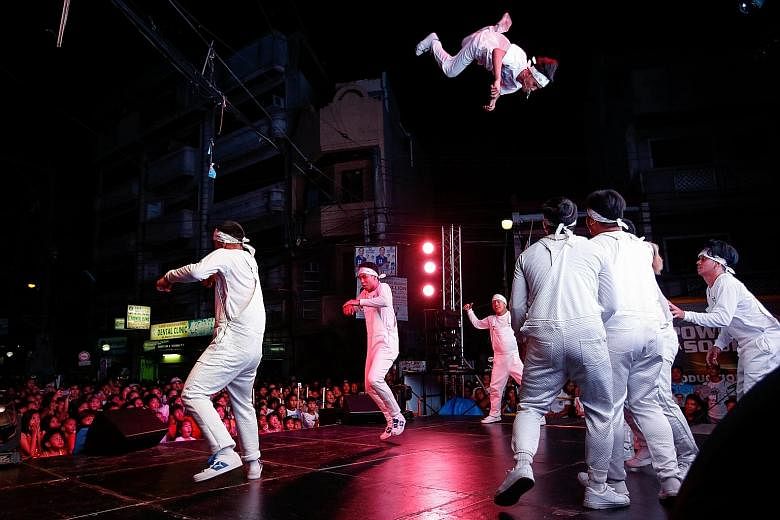 Dancers at a campaign event in Manila for the Philippines' midterm elections. On Monday, more than 60 million Filipinos will head to the polls to elect 12 senators, 297 district representatives and some 18,000 provincial, city and town officials.