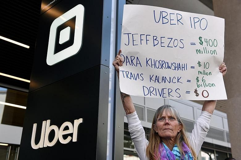 An Uber driver at a strike in San Francisco, California, on Wednesday against the company's recent 25 per cent wage cut. Uber's IPO would reward early backers like investor Jeff Bezos and co-founder Travis Kalanick, as well as chief executive Dara Kh