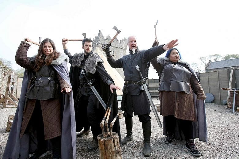 Game Of Thrones fans take part in axe-throwing with Master of Arms Will van der Kells (second from right) at the Castle Ward Estate in Strangford, Northern Ireland, the location of Winterfell in the hit HBO series.