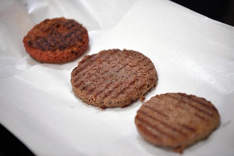 Cooked patties made of (from left) Beyond Meat; Impossible meat; and real beef.